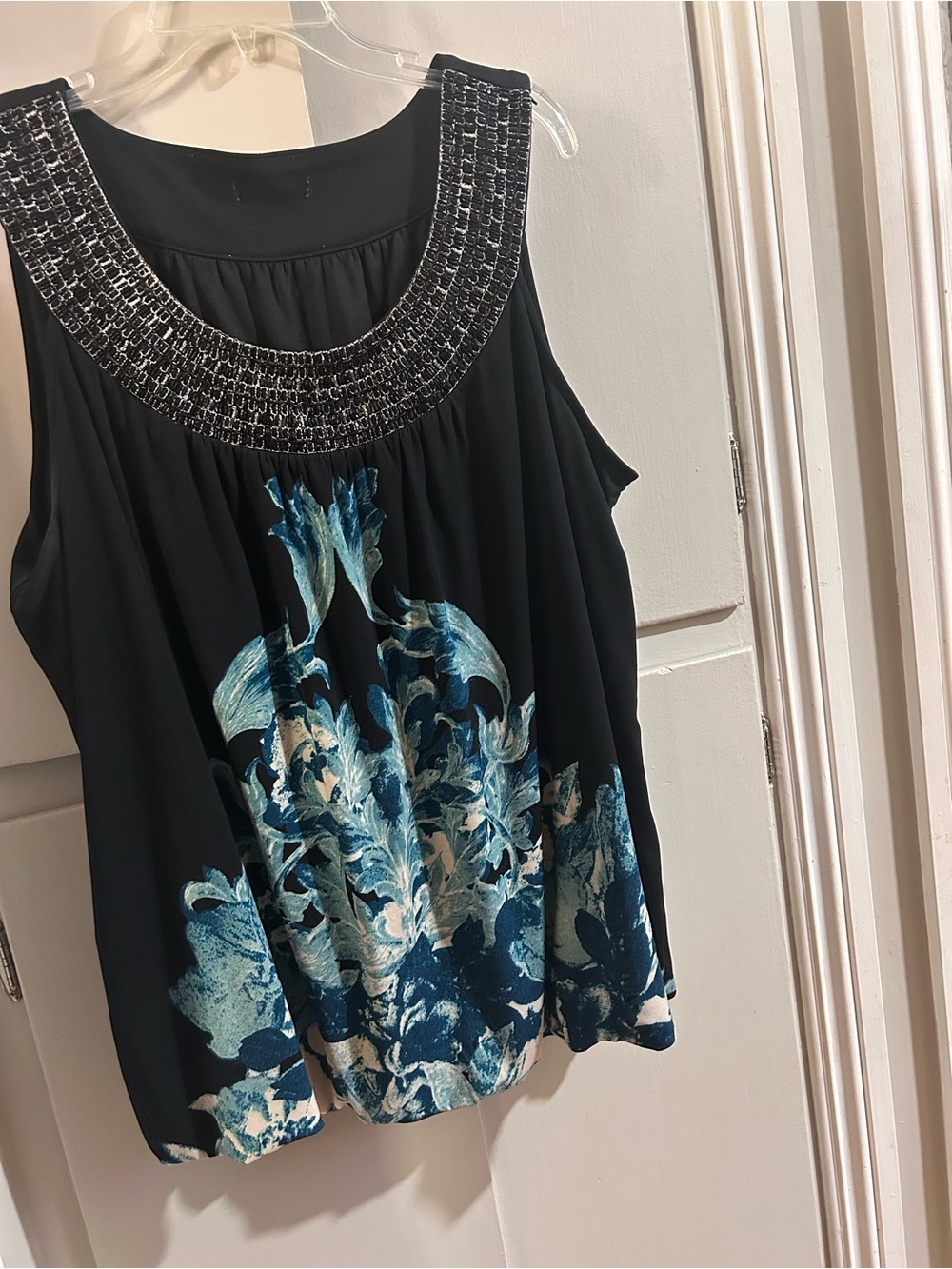 Sleeveless Black Top with Blue Floral Print and Embellished Neckline